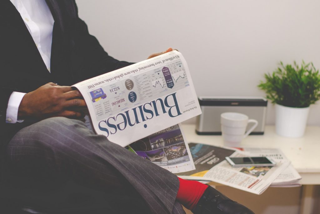 a business person reading a business publication on Pure Sunfarms