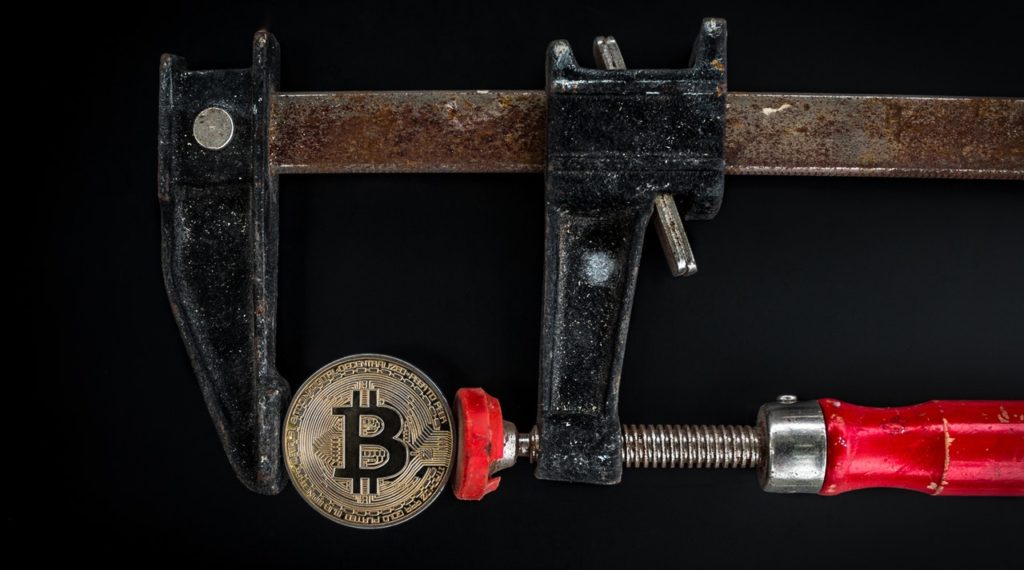 a wrench and a bitcoin, symbolizing the strength of cannabis and cryptocurrency