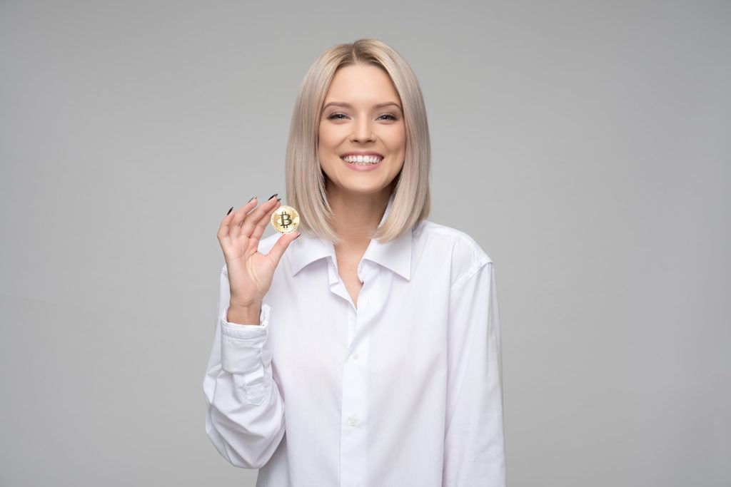 A woman holding cryptocurrency representing using blockchain technology with cannabis