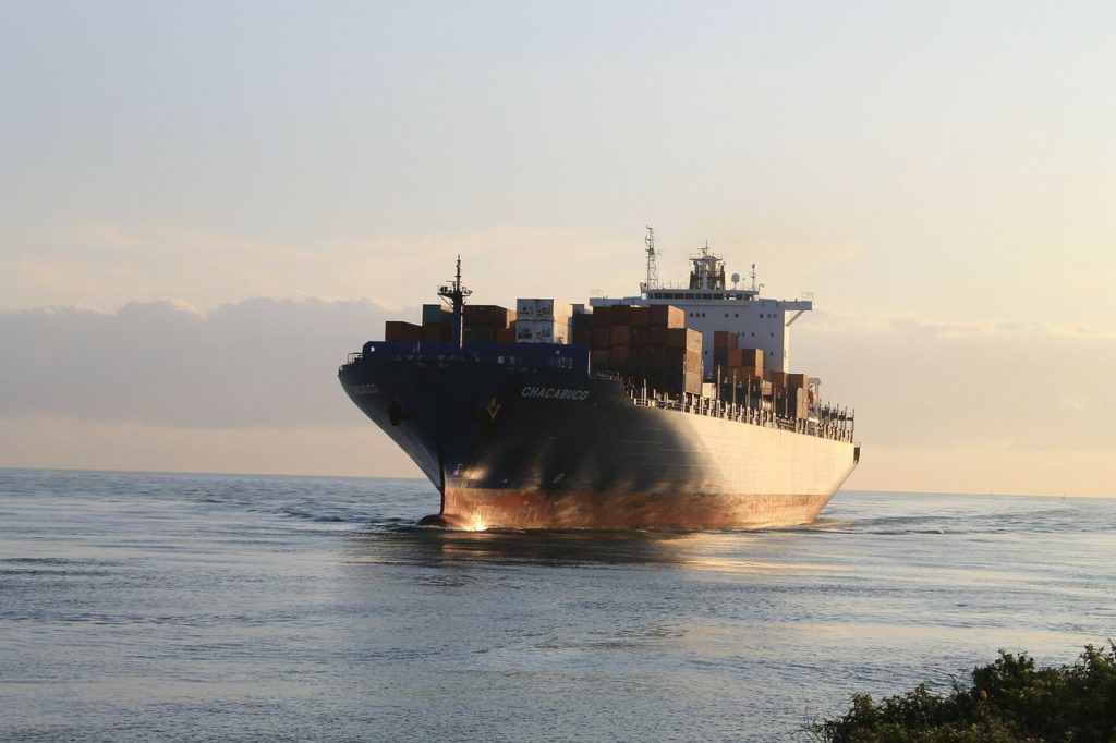 a large cargo ship, in open water, on a clear day, representing exporting from Israel's cannabis industry