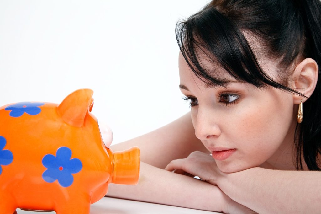 woman looking at piggy bank to represent the hope that there is no cannabis liquidity crisis