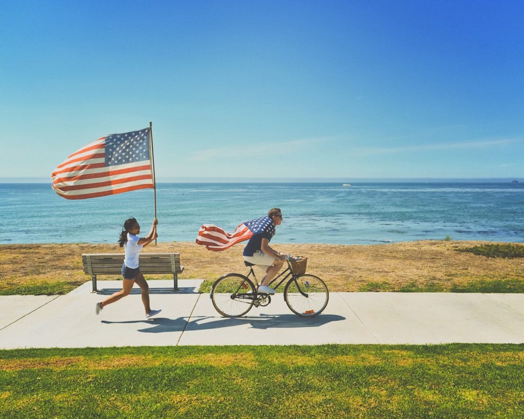 A picture of Americans and American flags representing the U.S. cannabis industry 