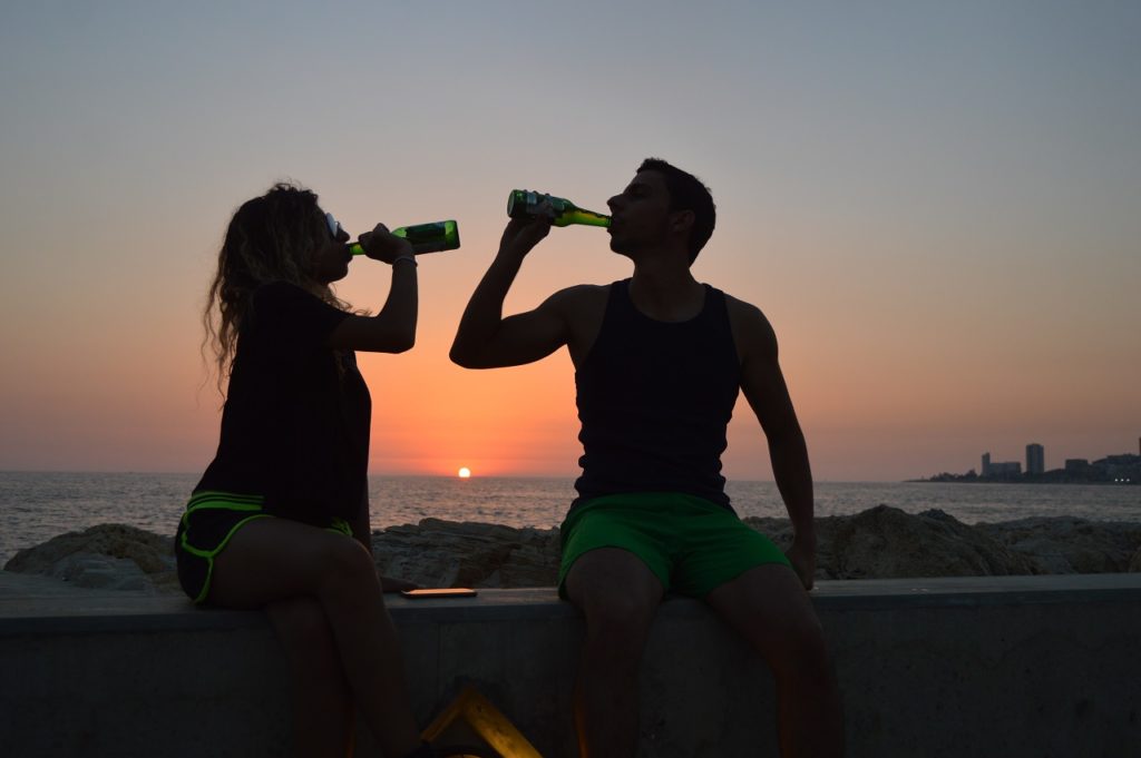 Two people drinking cannabis-infused beverages