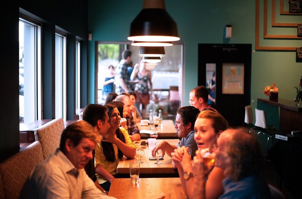 People at a bar representing cannabis-infused beverages