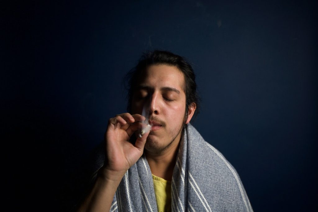 Man enjoys recreational cannabis joint